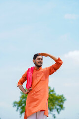 Indian farmer standing on bricks and watching on sky