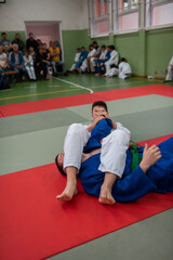 Two judo fighters showing technical skill while practicing martial arts in a fight club. The two fit men in uniform. fight, karate, training, arts, athlete, competition concept.Selective Focus
