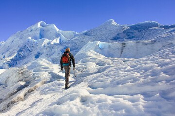 Mid-adult hiker on ice surface of melting Perito Moreno Glacier, Los Glaciares National Park, El...
