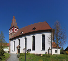 Fototapeta na wymiar Bürglein village church with its nave and its gothic tower in Heilsbronn municipality, Franken region in Germany
