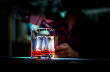 woman hand bartender making negroni cocktail in bar