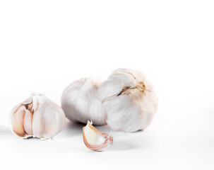 fresh organic garlic isolated over white background, full heads, cloves and peels, cooking ingredients. High quality photo