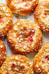 Homemade yeast sweet buns with rhubarb and butter crumble, close up view