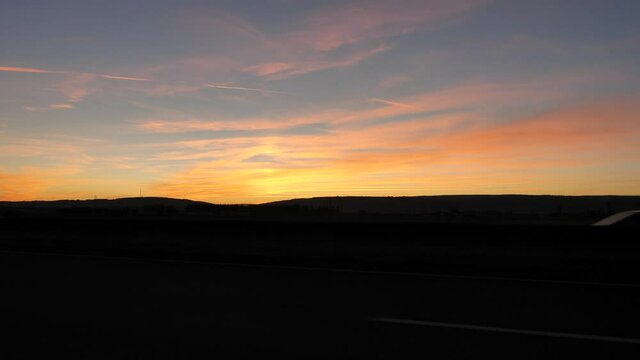 On the road, a sunset while driving between Beaune and Dijon. Burgundy, France.
