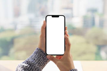 close up hand holding mock-up phone blank screen and cityscape b - 468929940