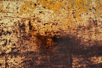 A rusted wet yellow and brown metal surface
