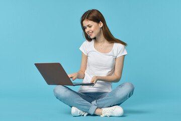 woman with laptop learning internet online education blue background