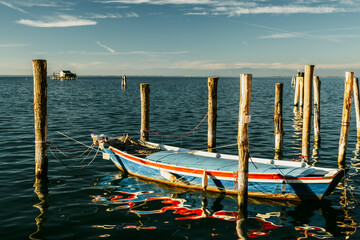 Fishing boat moored between the briccole, Pellestrina island, Venetian lagoon, Italy