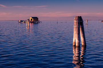 View on the Venetian lagoon with the  fishermen's house, Pellestrina island, Venetian lagoon, Italy