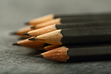 Obraz premium Black wooden pencils on a rustic background. 