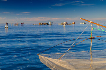 View on the Venetian lagoon with the  fishermen's houses, Pellestrina island, Venetian lagoon, Italy