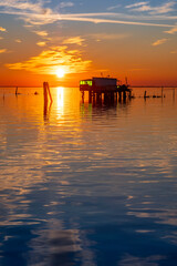 Sunset on the Venetian lagoon with the  fishermen's houses, Pellestrina island, Venetian lagoon, Italy