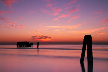Sunset on the Venetian lagoon with the  fishermen's houses, Pellestrina island, Venetian lagoon, Italy