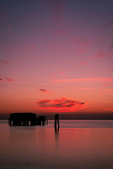 Sunset on the Venetian lagoon with the  fishermen's houses, Pellestrina island, Venetian lagoon, Italy