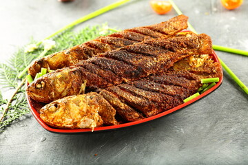 Homemade delicious and spicy fish fry, fried sea food with exotic spices and herbs.