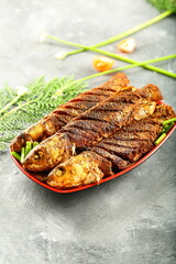 Homemade delicious and spicy fish fry, fried sea food with exotic spices and herbs.