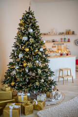 White snowy Christmas tree with gifts decor interior of the house, New year 