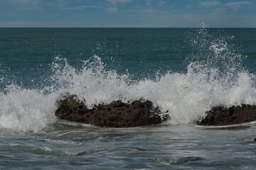 Fototapeta premium West Africa. Senegal. The waves of the Atlantic Ocean beat against the rocks of volcanic origin on the beach of the resort town of Ngaparou.