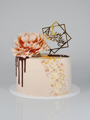 Pink colour chocolate cake with a flower and chocolate ganache