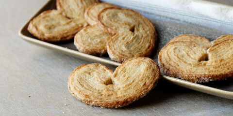 Palmier cookies on a plate. Traditional sweet puff pastry dessert with sugar.