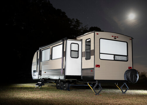 Camping trailer with slide out and moon above