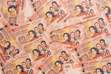 Bolivian money, A lot of 100 Boliwianos banknotes scattered on the table, filled with a frame