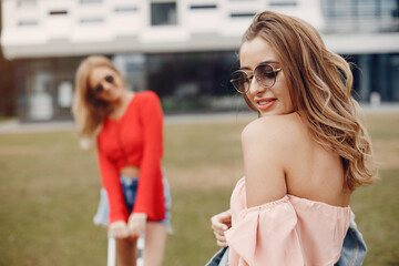 Elegant and stylish girls in a spring park