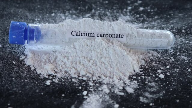 Calcium carbonate in test tube and black background