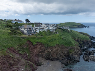  Scenic panorama view of houses and villa on the cliffs near the beach of Bigbury on Sea, Kingsbridge, Devon in England, UK with Burgh island in the background. Drone aerial bird eye view