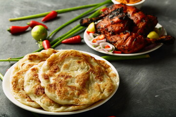 Indian cuisine  - homemade delicious paratha served with grilled chicken.