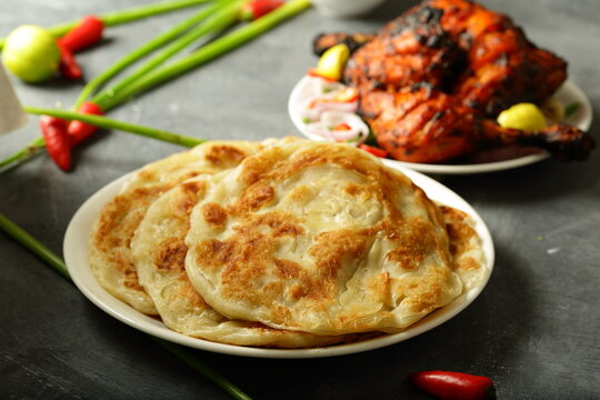 Indian cuisine  - homemade delicious paratha served with grilled chicken.