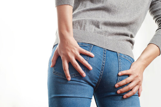 concept of health problems woman has hemorrhoids
