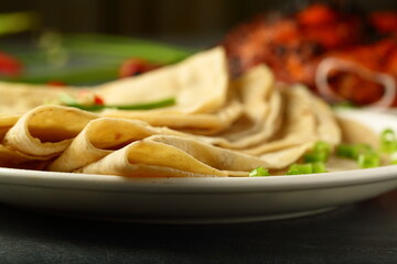 Traditional Indian bread chapattis served with grilled chicken, 