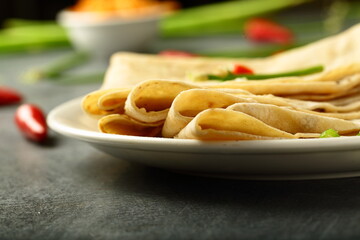 Indian street foods background- traditional breads chapattis served in a plate. 