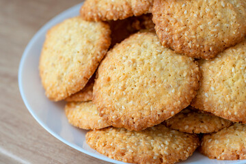 Sesame cookies on a plate. Pile, heap of sesame cookies.  Delicious and sweet sesame cookies.