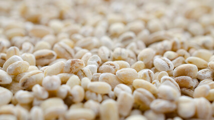 Pearl barley background close-up, top view. Pearl barley closeup, grain texture, top view. Pearl barley is processed barley grains that have been processed.