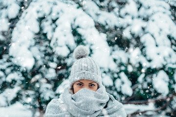 Beautiful young woman wearing scarf and a a hat on a cold winter day