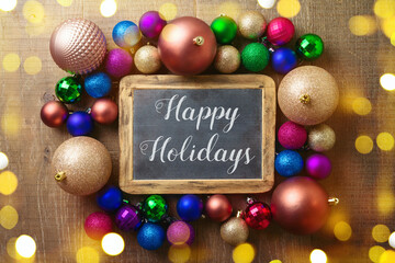 Fototapeta na wymiar Happy Holidays greeting background with trendy modern balls ornament. Top view with copy space