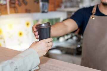 Fototapeta na wymiar Coffee Time. waiter staff or barista serving hot black coffee cup to female customer in cafe coffee shop, cafe restaurant, service mind, small business owner, takeaway food, food and drink concept
