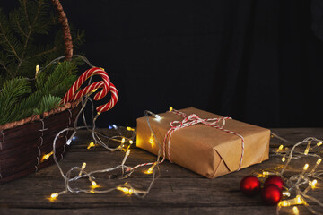 christmas composition: gift, fir branches and lollipops