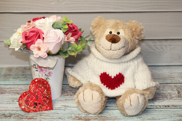 teddy bear with heart and with a bouquet of flowers