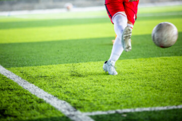 Obraz premium Blurry picture of soccer player shoot football.