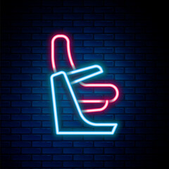 Glowing neon line Airplane seat icon isolated on brick wall background. Colorful outline concept. Vector