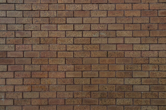 bricks red and broen color arranged in rows on wall