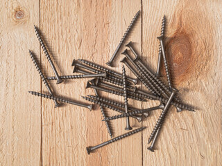Wood screws on a wooden board - 468958564