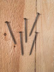 Wood screws on a wooden board - 468958589