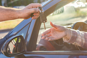 Buying and renting cars. Transfer of the car key in close-up