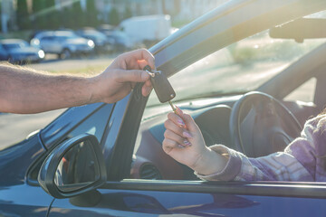 Buying and renting cars. Transfer of the car key in close-up