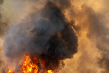 raging dust smoke pattern background of fire burn in grass fields, forests and black