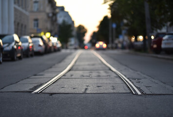 Fototapeta na wymiar ending tramway rails on evening street in selective focus